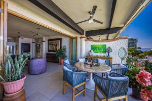 an outdoor patio with a table and chairs at Charming condo featuring ocean views, pool & private terrace in Puerto Vallarta