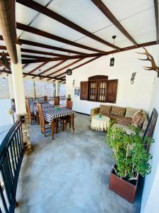 a living room with a couch and tables at Neo Grand Villa in Galle