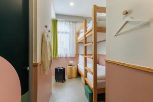 a small room with bunk beds and a staircase at mu petite in Ipoh