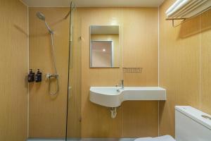 a bathroom with a sink and a shower at mu petite in Ipoh