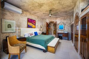 a bedroom with a bed and a desk and a table at Charming condo featuring ocean views, pool & private terrace in Puerto Vallarta +31 photos