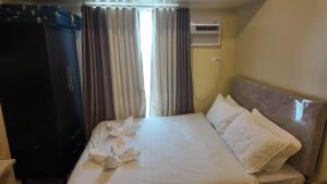 a bedroom with a bed with two candles on it at Ann's Haven in Cebu City