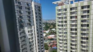 a view of two tall buildings from a window at Ann's Haven in Cebu City