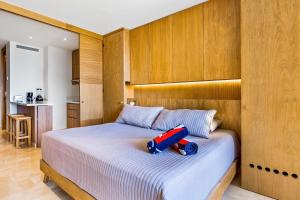 a bedroom with a bed with a toy on it at Oceanfront Gem with Bay View Terrace & Direct Sea Access in Cruz de Huanacaxtle +31 photos