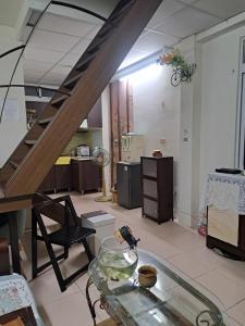 a living room with a glass table and a staircase at 包棟Linsen Secret Realm 27 in Tainan +14 photos