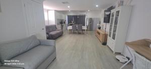a living room with a couch and a table at Oscar's at Banora in Kurrara
