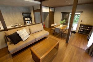 a living room with a couch and a table at Fukugi Beach Villa Okinawa in Nakijin