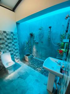 a bathroom with a toilet and a sink at Neo Grand Villa in Galle +97 photos