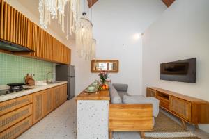 a kitchen with a couch and a table in it at Sunset Heaven - Private Pool Cozy Villa with Patio in Kerobokan