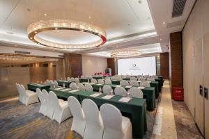 a conference room with green tables and white chairs at Lia Charlton Hotel Shenzhen in Shenzhen