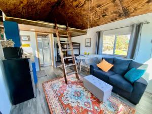 a living room with a blue couch and a table at Blue Moose Cabin at Moose Tracks Lodging in Kenai