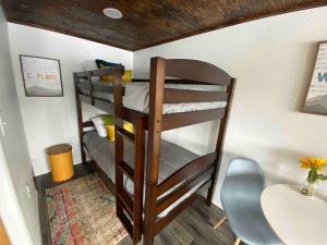 two bunk beds in a room with a sink at Blue Moose Cabin at Moose Tracks Lodging in Kenai