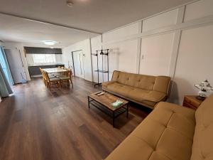 a living room with a couch and a table at 京阪楽宿 in Kadoma