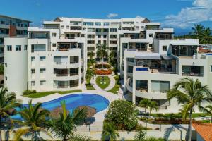an aerial view of a resort with a swimming pool at Stylish condo with covered balcony, pool & pool tables in Nuevo Vallarta