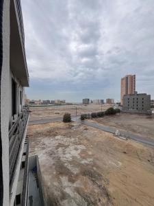 a view of a building with a road and buildings at Ocean Bliss Jacuzzi - Sea View- Check-in in Al Khobar