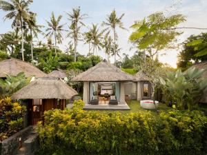 a villa with a resort in the middle of a garden at Maya Ubud Resort & Spa in Ubud