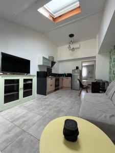 a living room with a couch and a table at Gite Matilon, 5 min Eugénie les Bains in Buanes +9 photos