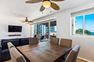 a dining room with a table and a couch at Ocean-view condo with private rooftop pool, terrace, & resort-style pool in Nuevo Vallarta