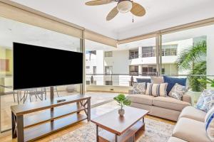 a living room with a large flat screen tv at Ocean-view condo with resort pool & sundeck in Nuevo Vallarta
