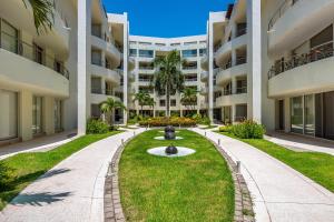a courtyard with a fountain in the middle of a building at Ocean-view condo with resort pool & sundeck in Nuevo Vallarta