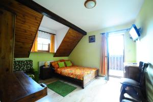 a bedroom with a bed and a large window at Przystań Jaskółka in Ruciane-Nida