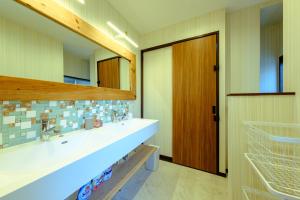 a bathroom with a sink and a mirror at 六鶴亭-ビーチ徒歩8分,スーパー徒歩2分,駅徒歩12分 in Manazuru