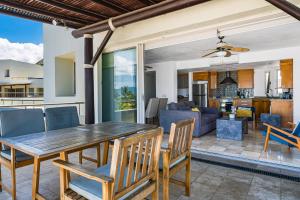 a dining room and living room with a table and chairs at Ocean-view condo with private rooftop pool, terrace, & resort-style pool in Nuevo Vallarta
