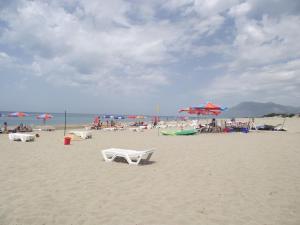 a group of people on a beach with umbrellas at Dardanos Hotel in Patara