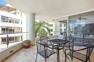a patio with a table and chairs on a balcony at Ocean-view condo with resort pool & sundeck in Nuevo Vallarta