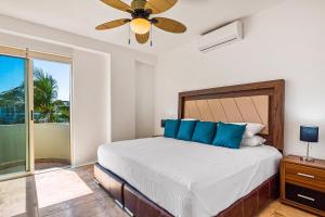 a bedroom with a bed and a ceiling fan at Ocean-view condo with private rooftop pool, terrace, & resort-style pool in Nuevo Vallarta +30 photos