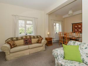 a living room with a couch and a table at Gardener's Cottage in Llandrindod Wells