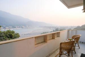 a balcony with chairs and a view of the ocean at Luxury 2 Bedroom's Appartment in Rishīkesh