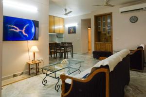 a living room with a couch and a glass table at Luxury 2 Bedroom's Appartment in Rishīkesh