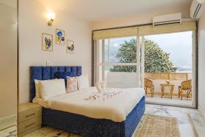 a bedroom with a bed and a large window at Luxury 2 Bedroom's Appartment in Rishīkesh