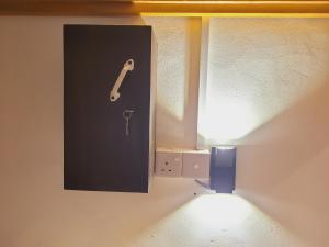 a wall with a picture of a saxophone on it at FMS Rooms & Hostel in Arugam Bay
