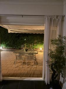 a patio with a table and chairs under a tent at Lotte's Cottage in Broken Hill