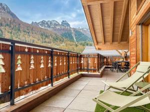 a balcony with chairs and a view of mountains at Elevate in Ovronnaz