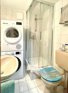 a bathroom with a shower and a washing machine at Eislinger Oase in Eislingen +8 photos