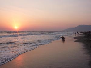 a group of people on the beach at sunset at Dardanos Hotel in Patara