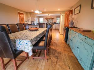 a kitchen with a table with leather chairs and a table sidx sidx sidx at Manor Wood in Coddington