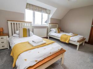 a bedroom with two beds and a window at Manor Wood in Coddington