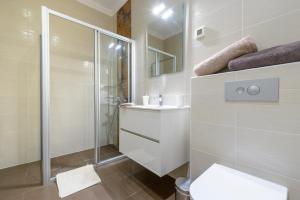a bathroom with a shower and a toilet and a sink at Villa Mediteran Old Town, 5 En-Suites and Hot Tub in Dubrovnik +69 photos