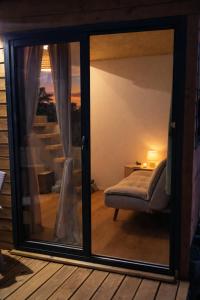 a room with a sliding glass door with a window at Ti kaz du piton in Cilaos