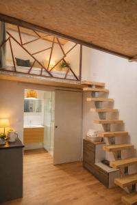 a room with a wooden staircase in a room with a kitchen at Ti kaz du piton in Cilaos