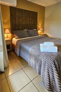 a bedroom with a bed with two towels on it at Pousada Marina do Sol in Florianópolis +26 photos