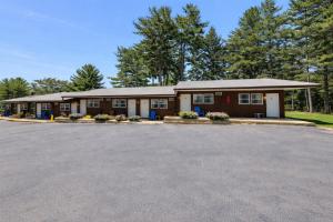 a building with a parking lot in front of it at Studio 6 Lake George NY Adirondacks in Lake George