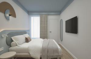 a bedroom with a bed and a television on a wall at Almara Green Hotel in Rimini