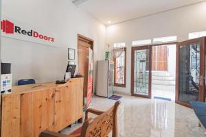 a red door sign on a wall in a room at RedDoorz near Exit Toll Tanah Baru Bogor in Bogor