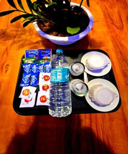 a tray with a bottle of water on a table at Cascade View in Cochin