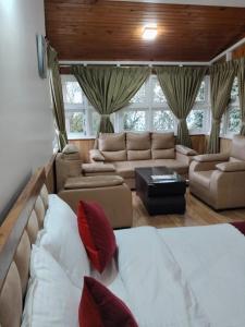 a living room with a bed and a couch at The Cup House in Namchi